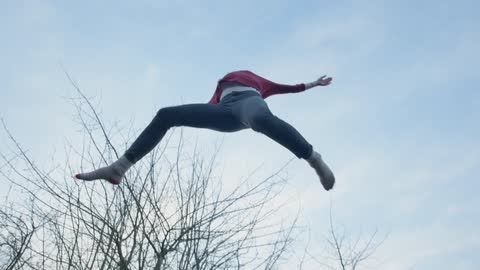 Teenager jumping on a trampoline
