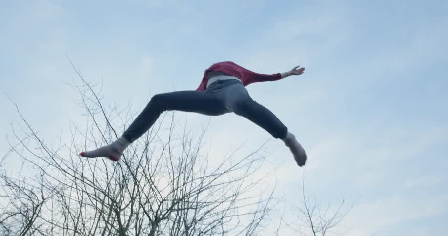 Teenager jumping on a trampoline