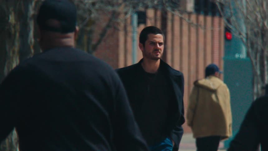People walking and crossing a street in a city