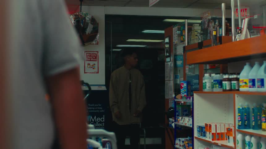 A customer enters the convenience store at night