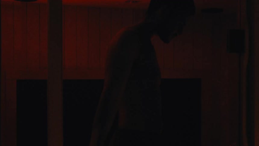 A man enters the shower and sits down