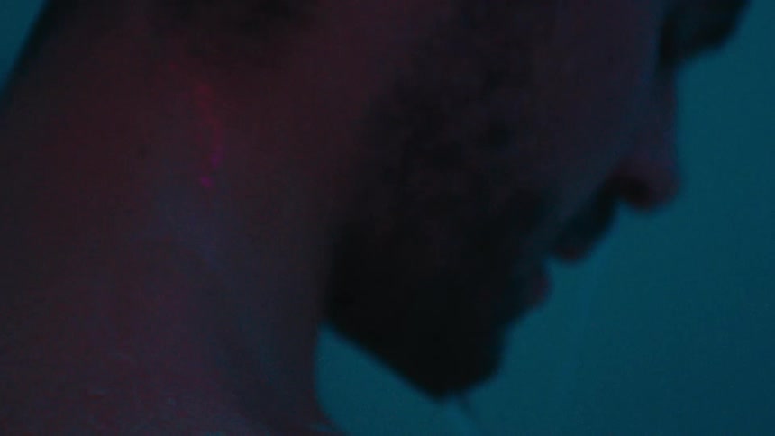 Closeup of a mans neck taking a shower