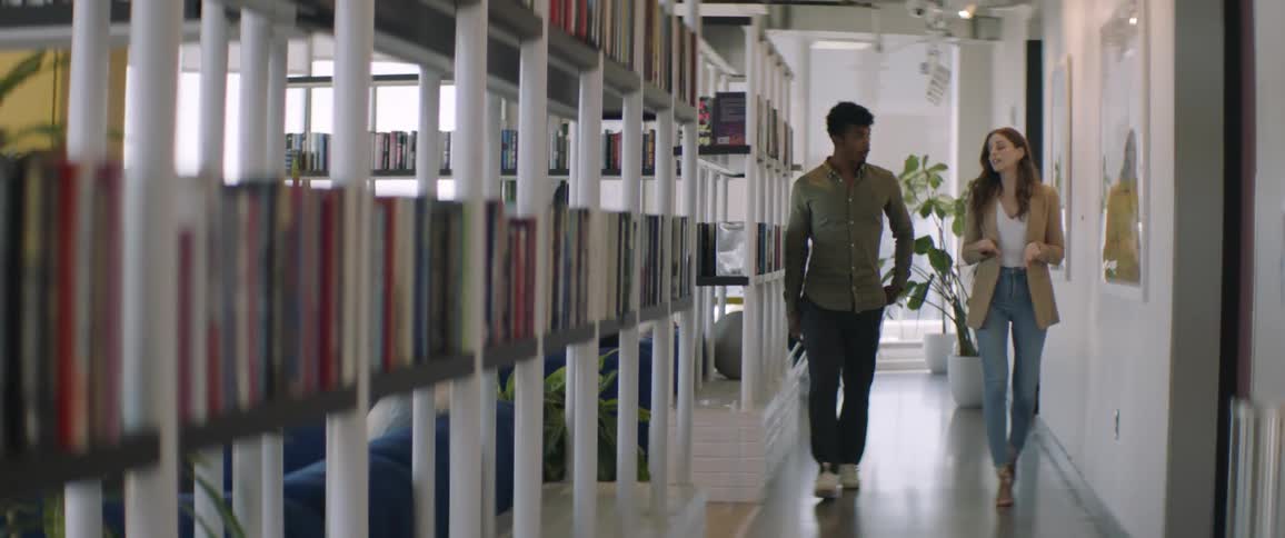 People walking and talking in a hallway in a work office