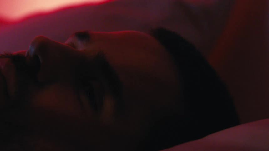 Portrait of a bearded man lying in bed