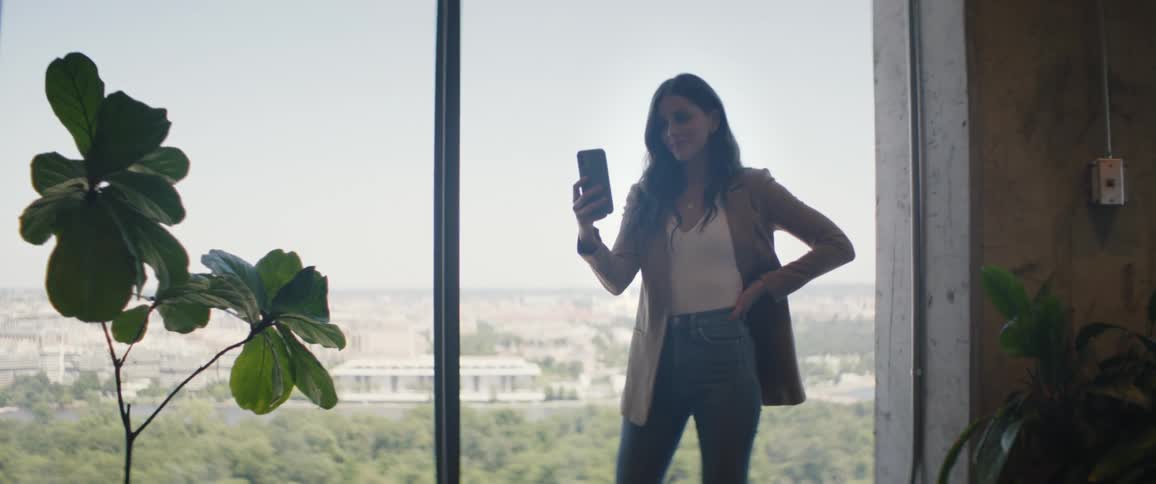 A woman uses her cell phone in the office
