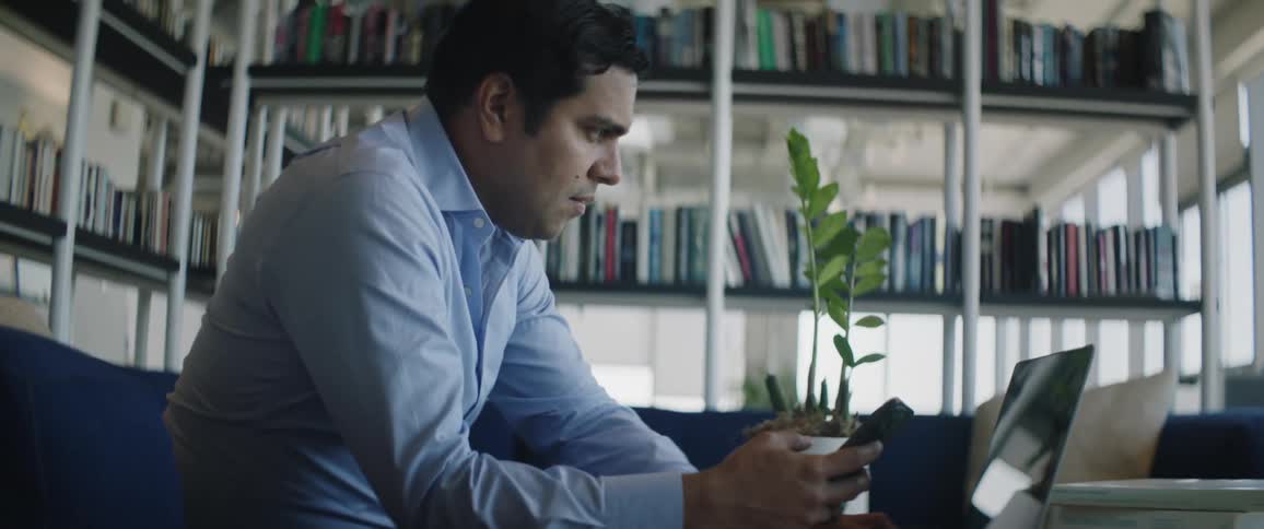 A man is typing on his laptop at home