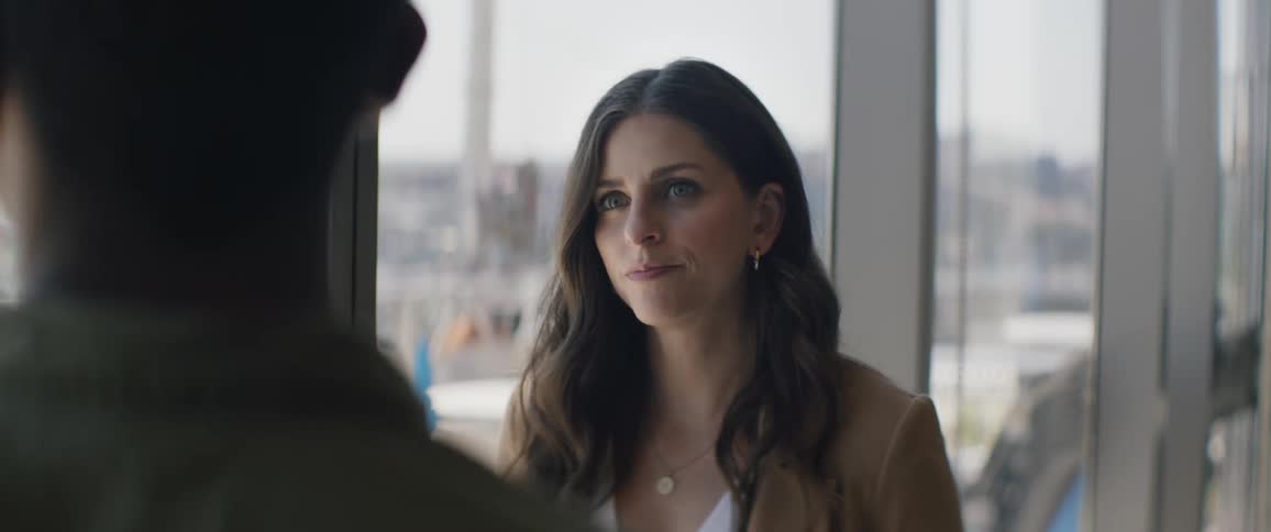 A woman is talking to a man in the office