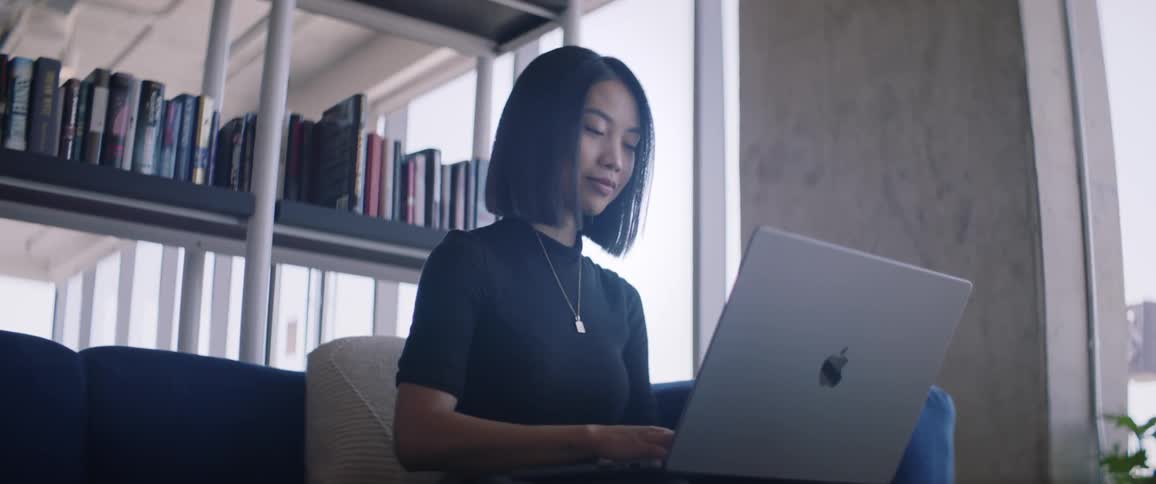 A woman types on her laptop in the office