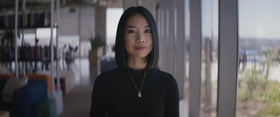 Portrait of a young woman with short hair wearing a necklace indoors