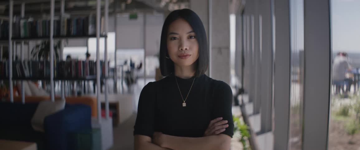 Portrait of a young woman with short hair and crossing her arms
