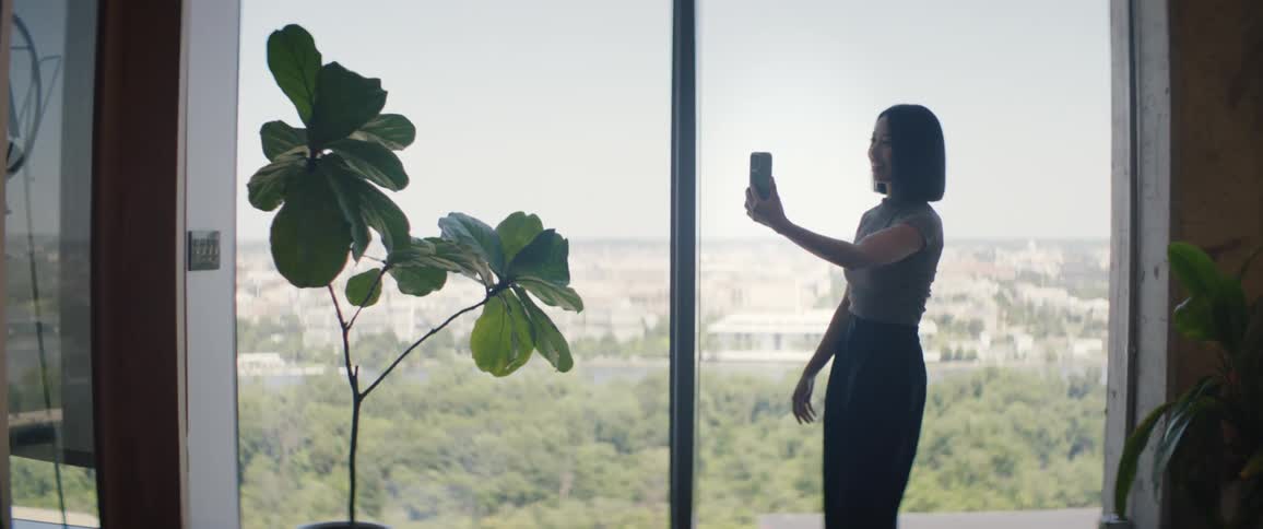Woman with a smartphone talking in selfie and saying goodbye