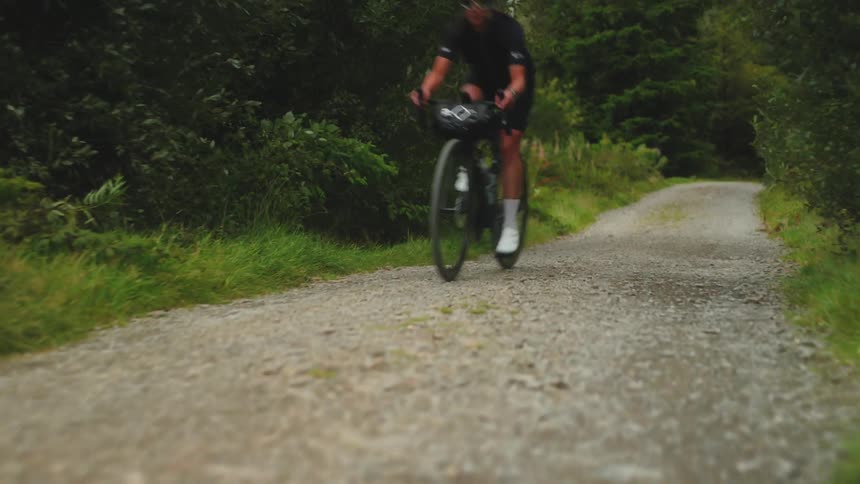 Woman on a gravel bike cycles fast