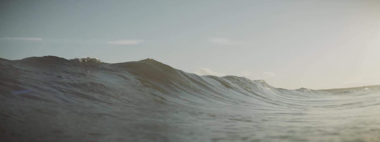The water is rough forming waves on a sunny day