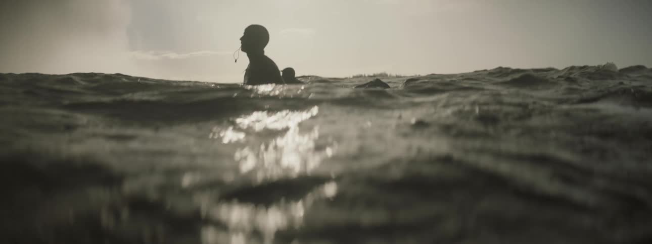 Surfers float on their surfboards in the ocean
