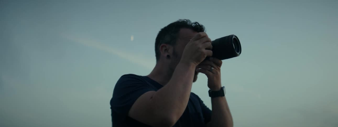 A man is taking photos outdoors