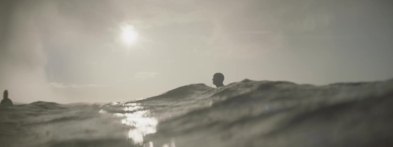 Two people floating on surfboards in the ocean