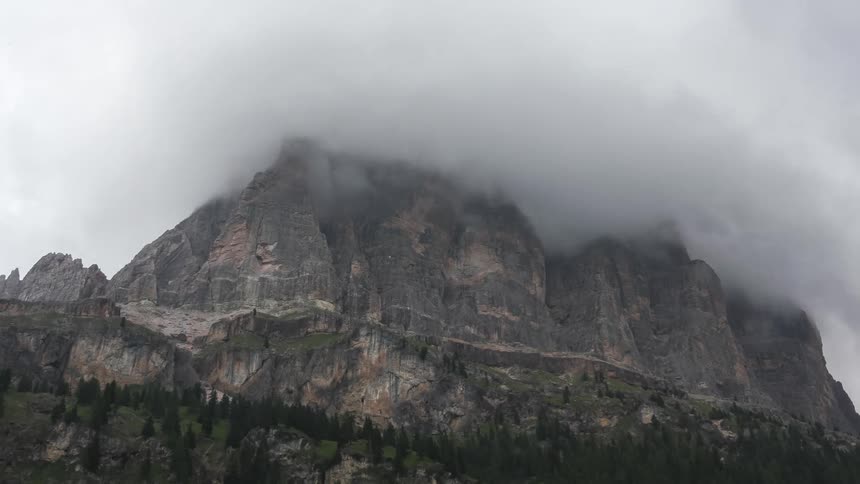 Impressive mountain with its peak partially hidden by low clouds