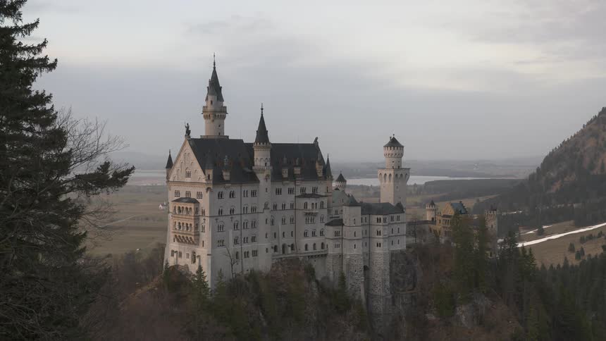 Castle in a ruin in a natural environment surrounded by mountains in a morning sky