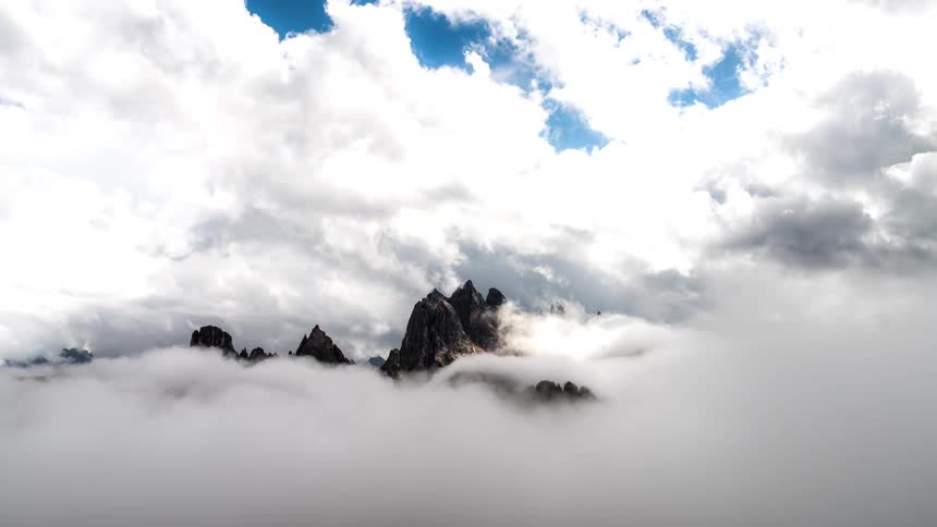 Time lapse time lapse of clouds rolling over steep mountain peaks
