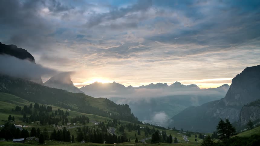Time lapse of sunrise over a mountainous landscape with peaks and valleys