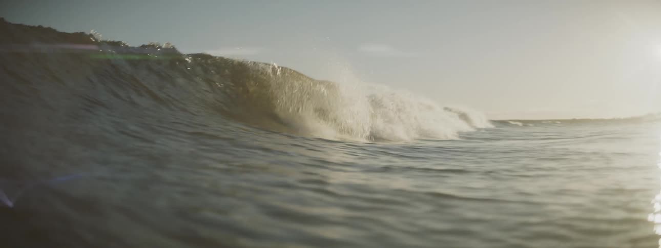 Rolling wave coming in and then covering the camera on a mostly clear day