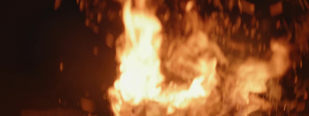 A bonfire of incandescent orange flame with lots of sparks coming out of it