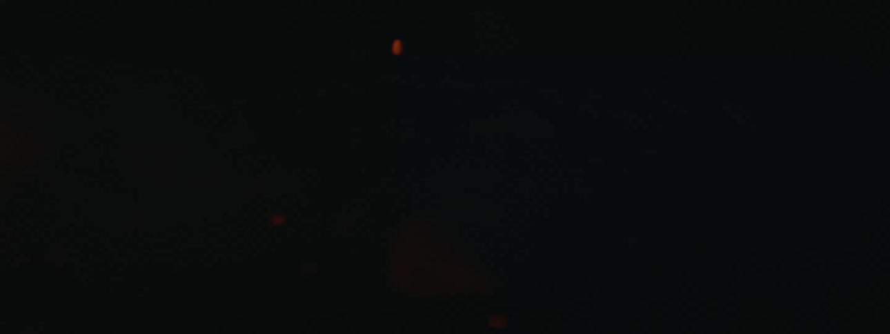 Intense orange and yellow flames against a dark background in nature