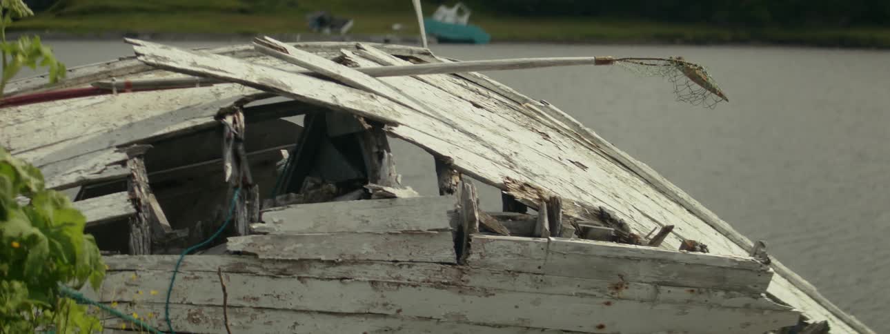 Destroyed wooden cabin by the sea
