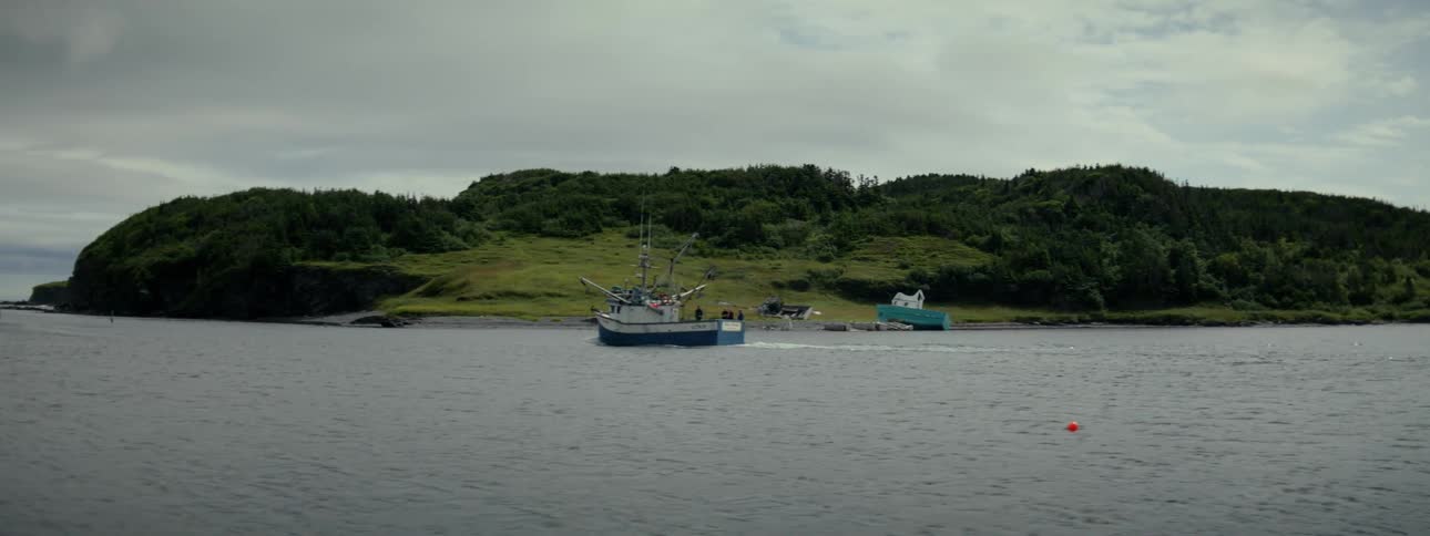 Boat traveling through an ocean near the coast