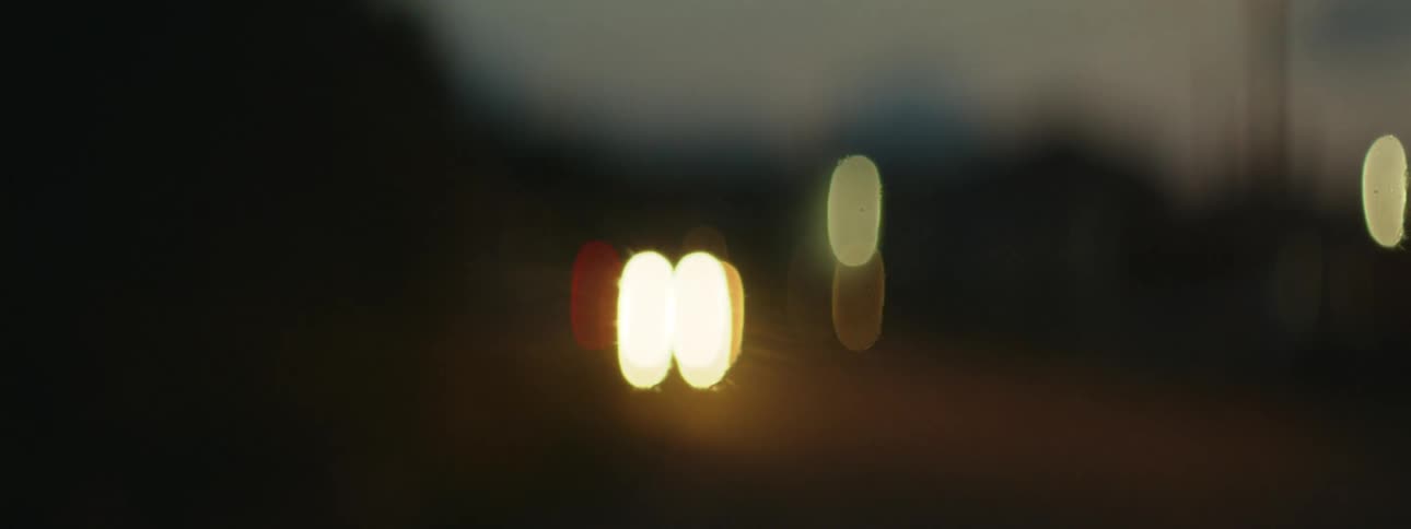 A headlight of a vehicle and everything is blurred