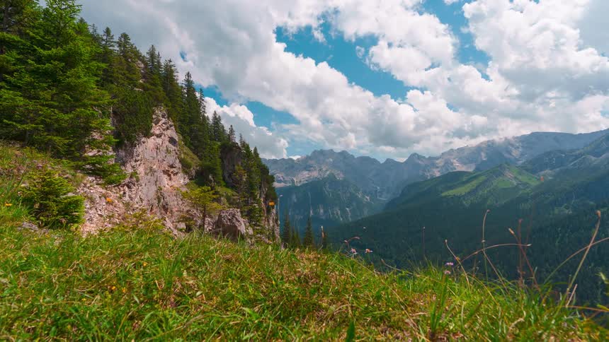 Landscape of a mountainous greenish valley with clouds passing by