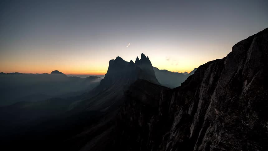The sun rises above the mountains