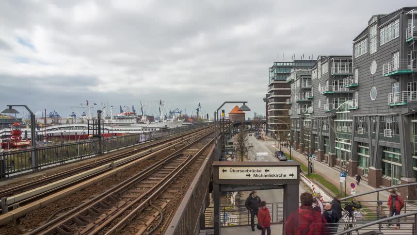 Crowds of people moving around a train terminal in a city