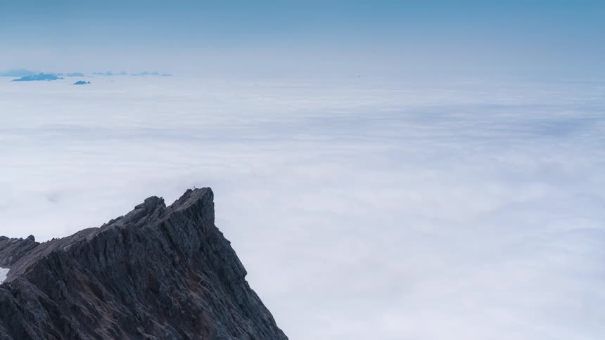 The mountain peaks above the clouds