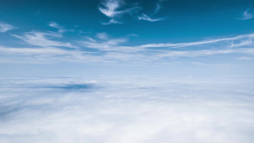 Vast expanse of white clouds under a clear blue sky