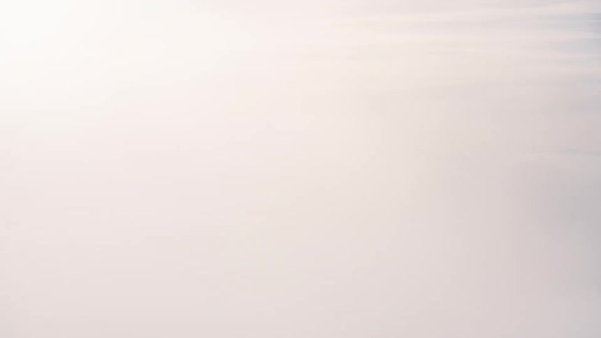 A high view of a horizon filled with rapidly drifting white clouds