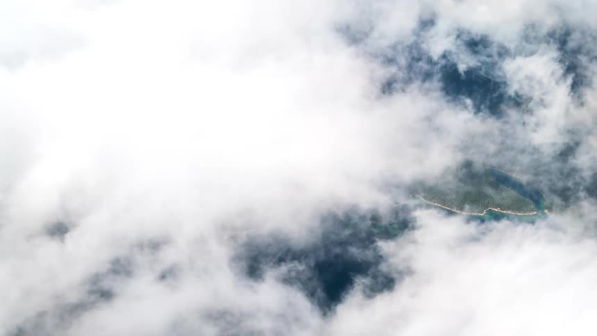 Dense white clouds passing quickly across the sky