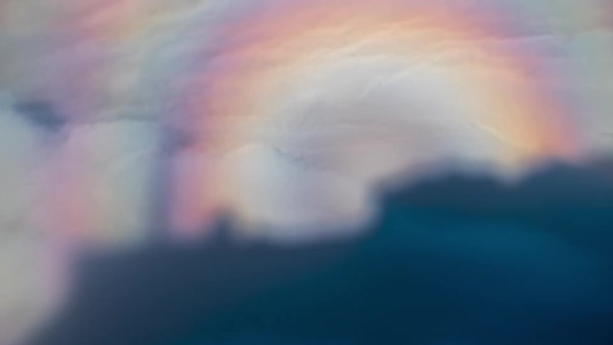 Rainbow in iridescent clouds