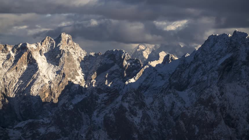 Landscape of mountain ranges covered by snow on a cloudy day