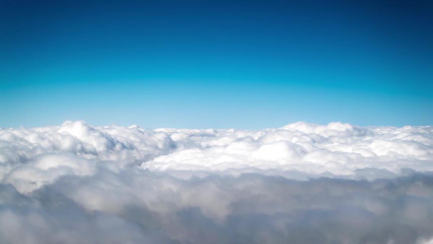 Vast expanse of white clouds under a clear blue sky