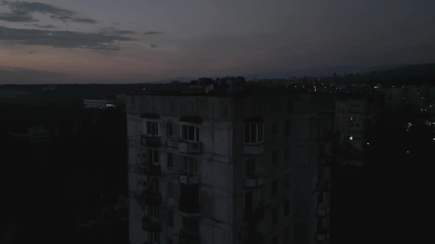 A residential building with several windows in one night