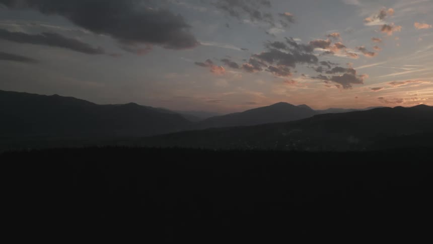 Landscape of mountain ranges in a dawn sky
