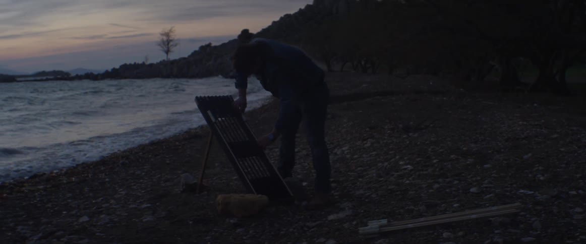 A man arranges flares on a wooden stand
