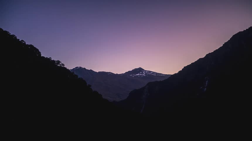 Mountain range with snow and the day getting dark