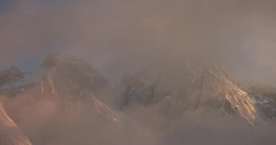 Red tinted fog covers mountainous terrain