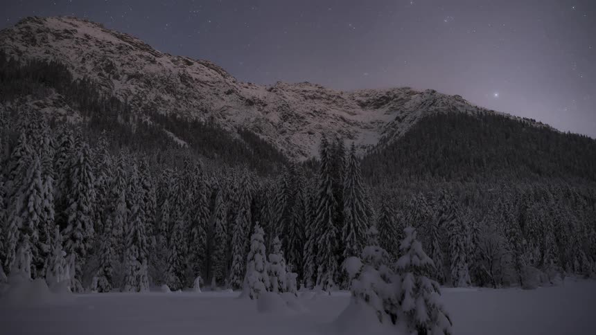 The sun sets on the mountain and the stars come out