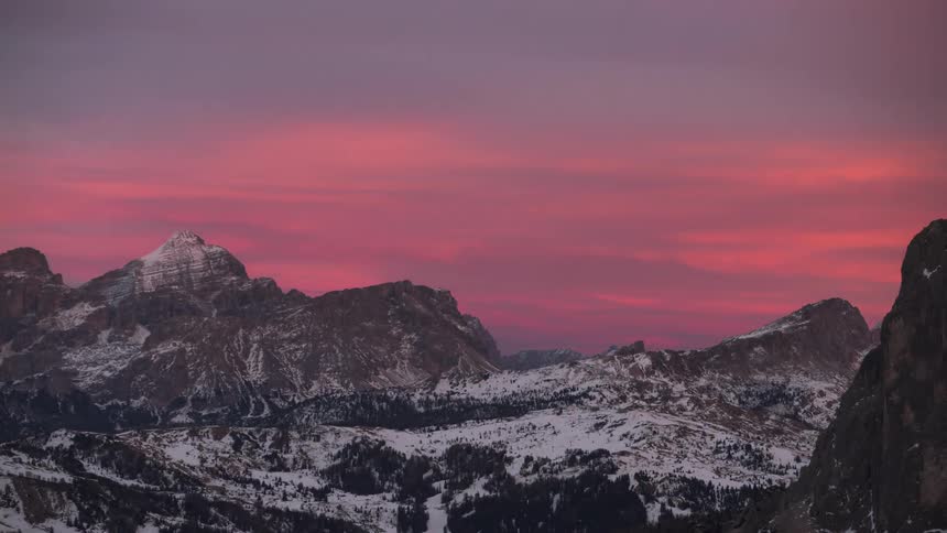 Snowy mountain range with red sky at dawn