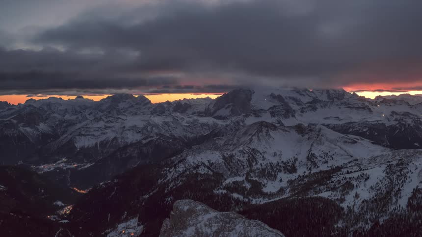 Time lapse of clouds rolling over a snowcovered mountain range