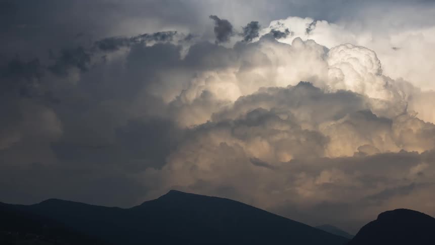 The clouds cast a shadow on the mountain