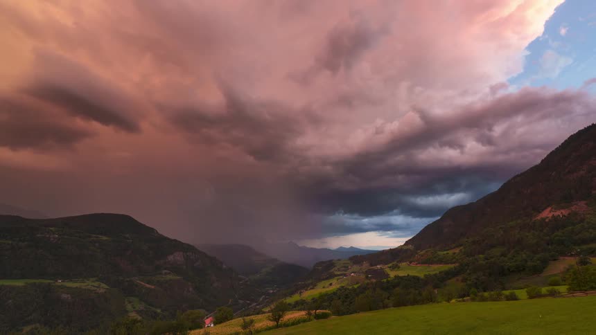 Storm clouds move over a rural mountain community at dusk